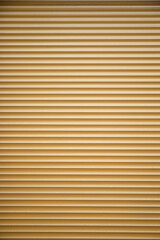 Yellow Metalic commercial roll up door texture .  Vertical shot, copy space