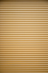Yellow Metalic commercial roll up door texture .  Vertical shot, copy space