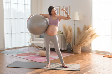 Healthy pregnant woman exercising and doing prenatal yoga, meditation, working out, yoga, pregnancy concept.