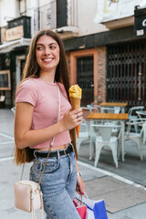 Young lady walks down the street smiling with an ice cream cone in her hand. Lifestyles