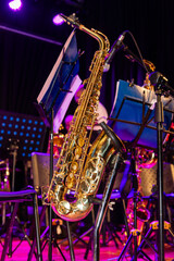 A saxophone is on a stand next to a music stand
