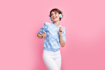 Photo of lovely carefree person have good mood enjoy listen favorite song dancing isolated on pink color background
