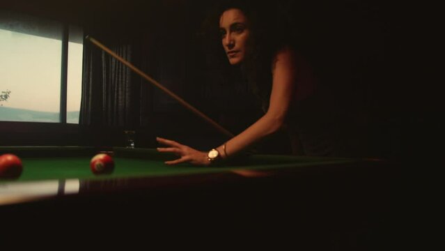 Woman playing pool in bar