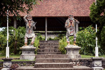 Fototapeta premium Traditional demon guard statue carved in stone in Bali island
