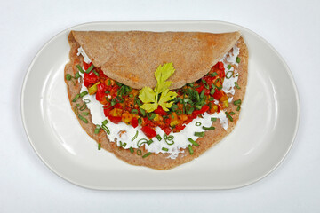 Pita Bread Filled With Egg White and Vegetables Breakfast Served at Oval Plate