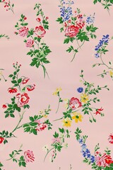 A pattern of small, colorful flowers and leaves scattered across the light pink background in shades of pink and green, evoking springtime joy.