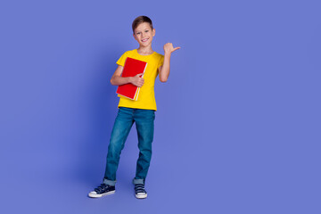 Photo of cute clever smart boy dressed stylish clothes showing empty space bookshop isolated on violet color background