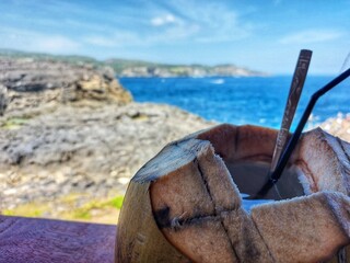 enjoy a young coconut with a view of the beach