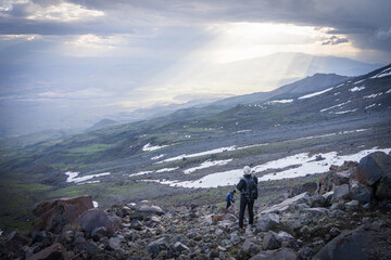 Fototapeta premium Hiker enjoying beautiful alpine landscape scenery hit by beams of sunlight, Mount Ararat in Turkey
