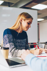 Positive male and female students doing homework together spending time in campus,colleagues making...