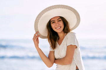 Portrait, smile and woman with sun hat at beach for summer travel, vacation and tourism in Miami....