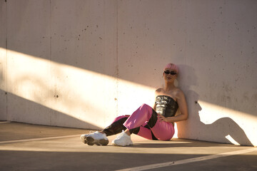 Attractive young gay man, heavily makeup, with pink hair, sunglasses, leather top and pants,...