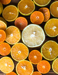 Orange fruit slices, half orange on wooden background