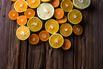 Orange fruit slices, half orange on wooden background