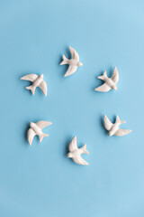 White swallows on blue background