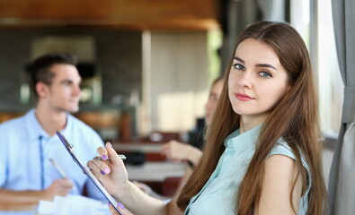 young beautiful woman have meeting with her subordinates in cafe - obrazy, fototapety, plakaty