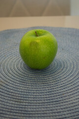 a green apple on a table