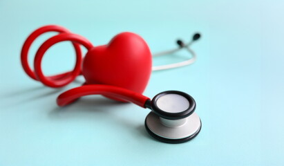 Red stethoscope with heart on blue modern background. Medical insurance concept