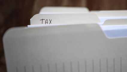 Close-up of important documentation in paper folders with handwriting inscription tax 2019. Preparation taxes data for annual audit reporting. State taxation system concept