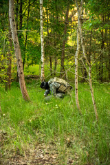 Ukrainian soldier sets up a tripwire in the forest