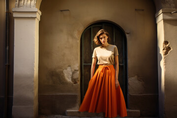 Beautiful woman wearing an orange pleated skirt.