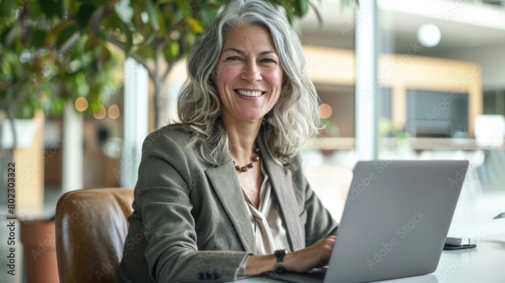 Wall mural confident woman with laptop at work