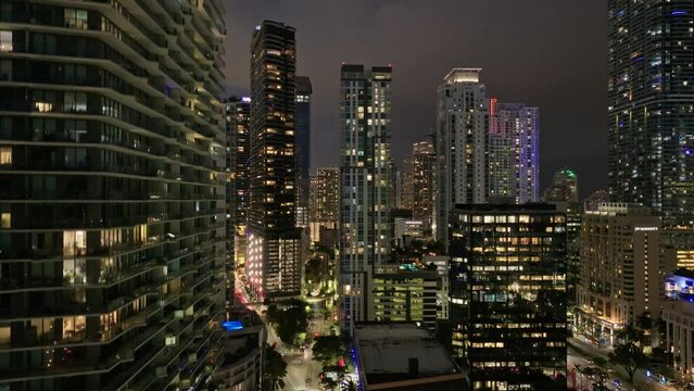 Establishing aerial view of Miami Brickell downtown skyline at night. Aerial drone view of Miami modern skyscraper, hotels and residential buildings at night. Miami Florida in 4K