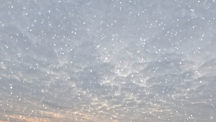 nice fall of snow on clouds on sky bg - photo of nature