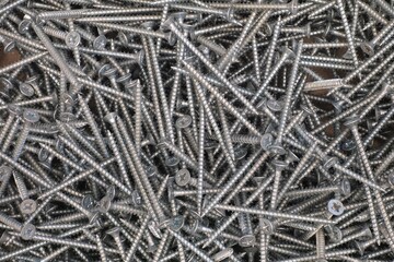 A pile of self-tapping screws. Full frame