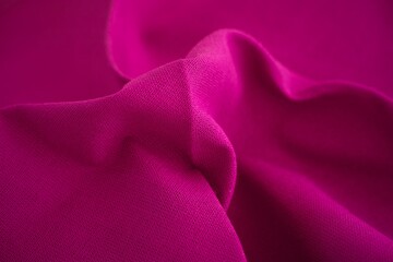 A close-up shot of magenta or crimson textile background.