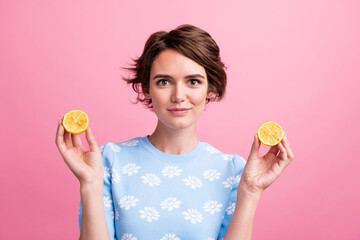 Photo of gorgeous nice lady hands hold two fresh lemon fruit halves isolated on pink color background
