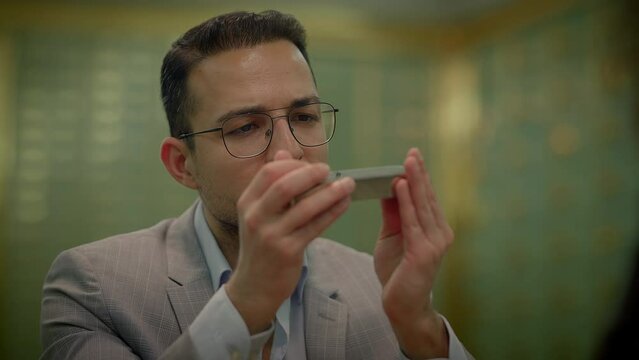 Businessman Looking at Silver Bar Bullion Discussing Protecting Investment