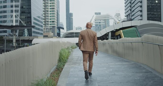 In heart of city businessman in business suit walking man finds solace in familiar streets, walking with purpose step by step resilience relaxation resolve amidst urban chaos walks at city streets.