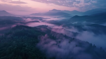 An aerial view captures the sprawling beauty of a misty mountain landscape at twilight