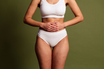 No filter cropped photo of lady underwear lingerie having stomach ache isolated khaki color...