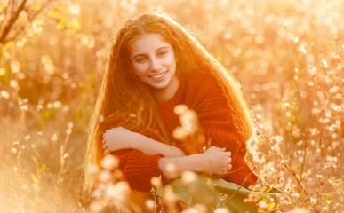 Happy teenage girl walking in autumn nature on yellow tree background