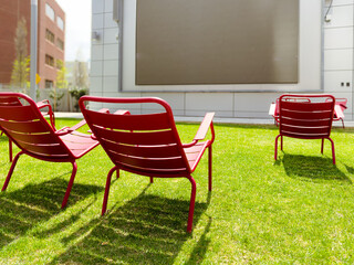 Outdoors summer movie theater with chairs on grass. Social event concept, life and work balance