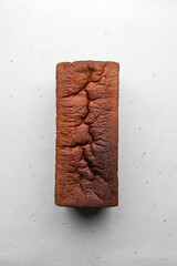 Simple Whole Wheat Sandwich Bread Loaf in Cassette on a White Background