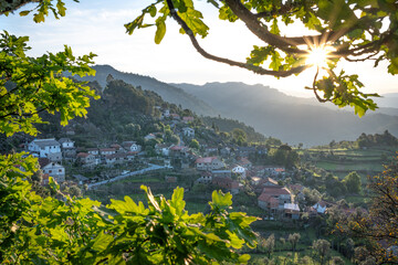 Morning sunrise view on Ermida do Gerês village from Miradouro da Ermida with sunstar, Parque...