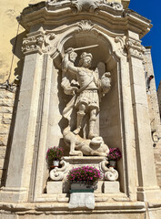 A stone fountain in an old town in Puglia, Italy