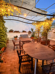 A rooftop dining terrace at dusk in Bari, Puglia in Italy