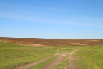 Fototapeta premium A field with dirt and grass