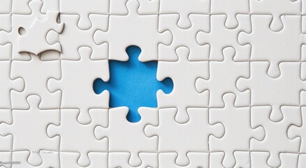 Fototapeta premium White puzzle with one piece removed, illustrating the missing link 