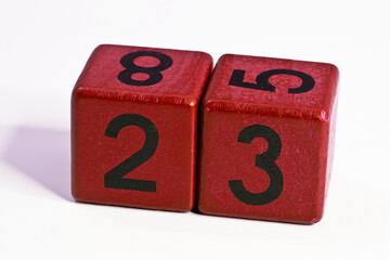 Number twenty three written on a red wooden cube of a calendar date