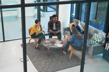 Creative agency, brainstorming and business people in meeting, glass wall and conversation with cooperation. Group, employees or staff in modern office, collaboration or laptop for research or choice