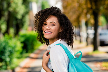 Photo of sweet cheerful woman dressed white shirt backpack enjoying warm weather walking college...