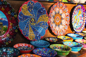 Colorful display of traditional Turkish ceramic plates and bowls, vibrant and intricately designed, cultural, design, and travel themes
