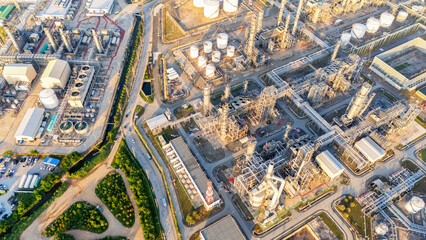 Oil refinery plant industry and port, Aerial view oil and gas petrochemical industrial, Refinery factory oil storage tank and pipeline steel at night, Ecosystem and healthy environment concepts.