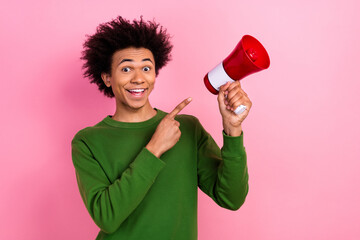 Photo of happy positive guy excited point finger loudspeaker isolated pastel color background