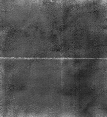A top down view of an aged black and white photograph with worn edges, showing the texture of old film. The background is dark grey with subtle grainy details, giving it a vintage look.